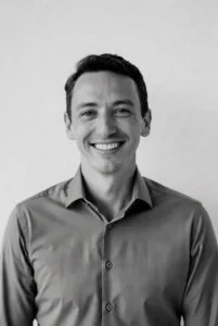 Man showing off a confident, transformed smile after porcelain veneers at Raleigh Prosthodontics